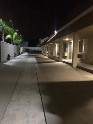 an empty hallway of a building at night at Royal Inn in Lomita
