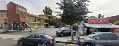 a group of cars parked in a parking lot at Travelodge by Wyndham Burbank-Glendale in Burbank