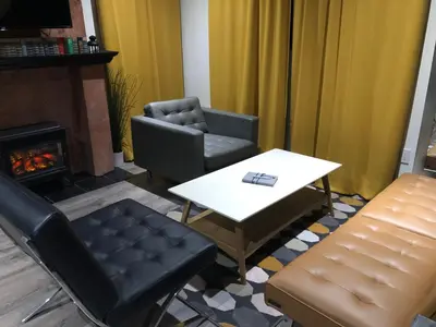 a living room with a table and chairs and a fireplace at VacaStay on Scandia Way in Los Angeles