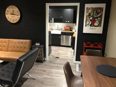 a kitchen and dining room with a clock on the wall at VacaStay on Scandia Way in Los Angeles