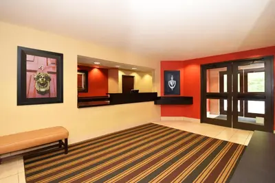 a waiting room with red walls and a mirror at Extended Stay America Suites - Los Angeles - Torrance Blvd in Torrance