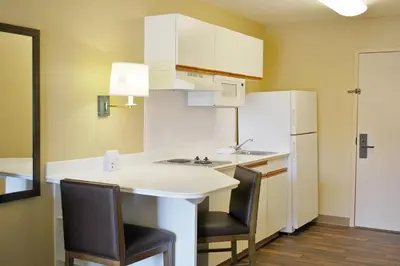 a kitchen with a white counter and two chairs at Extended Stay America Suites - Los Angeles - Monrovia in Monrovia