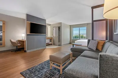a living room with a couch and a bed at Hyatt Place Riverside Downtown in Riverside