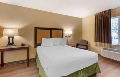 a hotel room with a large bed and a desk at Extended Stay America Suites - Los Angeles - Ontario Airport in Guasti
