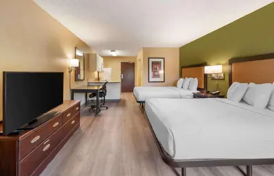 a hotel room with two beds and a flat screen tv at Extended Stay America Suites - Los Angeles - Ontario Airport in Guasti