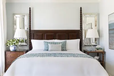 a bedroom with a large bed with two mirrors at Casa Del Mar in Los Angeles