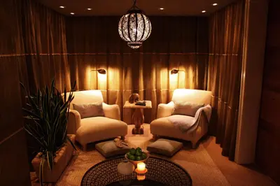 a living room with two chairs and a chandelier at Casa Del Mar in Los Angeles