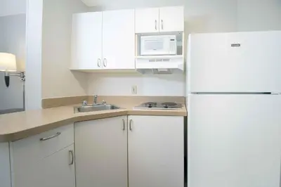a kitchen with white cabinets and a white refrigerator at Extended Stay America Suites - Los Angeles - Torrance - Del Amo Circle in Torrance
