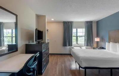 a hotel room with a bed and a flat screen tv at Extended Stay America Suites - Los Angeles - Burbank Airport in Burbank