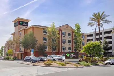 a building with cars parked in a parking lot at Extended Stay America Suites - Los Angeles - Burbank Airport in Burbank
