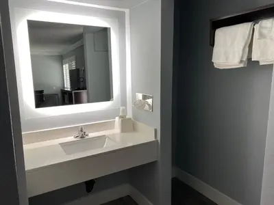 a bathroom with a sink and a mirror at Regency Motel in Brea