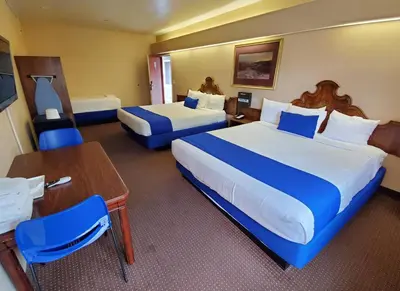 a hotel room with two beds and a table at Colony Inn in North Hollywood