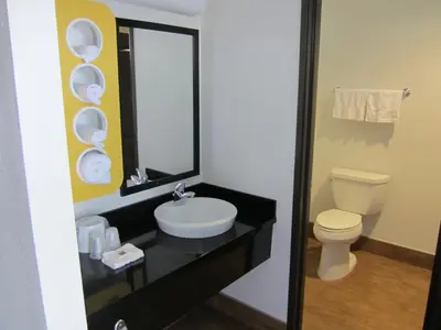 a bathroom with a sink and a toilet and a mirror at Motel 6-Anaheim, CA in Anaheim