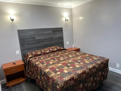 a bedroom with a bed and two night stands at Vegas motel in West Athens