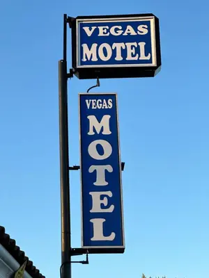 a neon sign for a vegas motel at Vegas motel in West Athens