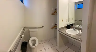 a bathroom with a toilet and a sink at Vantage Point Inn - Woodland Hills in Woodland Hills