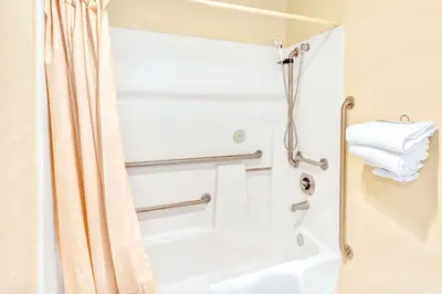 a shower in a bathroom with a shower curtain at Vantage Point Inn - Woodland Hills in Woodland Hills