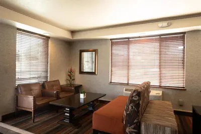 a living room with a couch and a table at Oxnard Inn Lancaster in Lancaster
