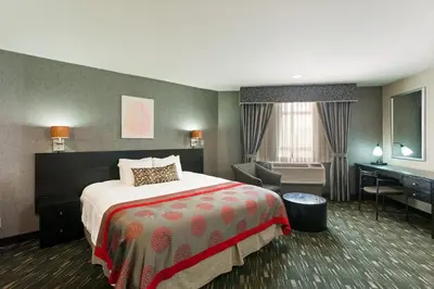 a hotel room with a bed and a desk at Ramada Plaza by Wyndham West Hollywood Hotel & Suites in Los Angeles
