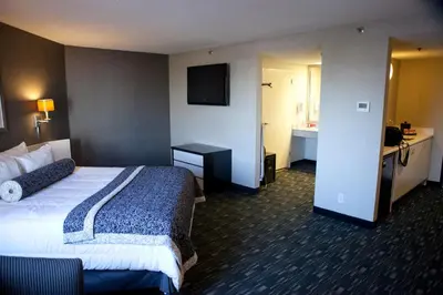 a hotel room with a bed and a bathroom at Ramada Plaza by Wyndham West Hollywood Hotel & Suites in Los Angeles