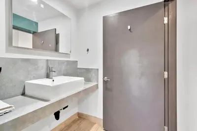a bathroom with a sink and a mirror at Exclusivo Inn and Suites in Lakewood