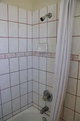 a bathroom with a shower with a tub at Sahara Motel in Anaheim