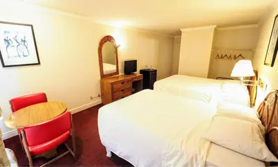 a hotel room with two beds and a table and a mirror at Grand Inn\u8ca1\u795e\u5ba2\u68e7 in Monterey Park