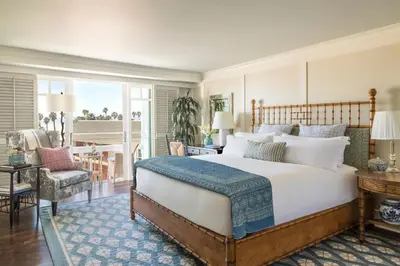 a bedroom with a large bed and a balcony at Shutters On The Beach in Los Angeles