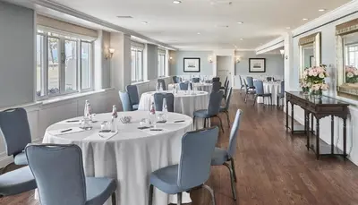 a conference room with tables and chairs and flowers at Shutters On The Beach in Los Angeles
