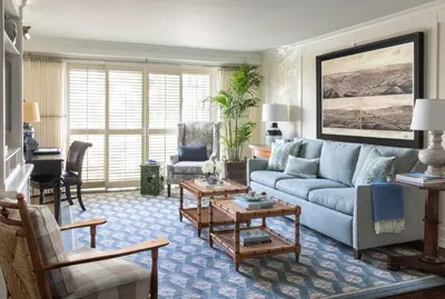 a living room with a couch and a table at Shutters On The Beach in Los Angeles