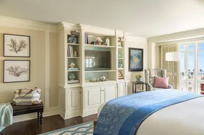 a bedroom with a bed and a book shelf at Shutters On The Beach in Los Angeles