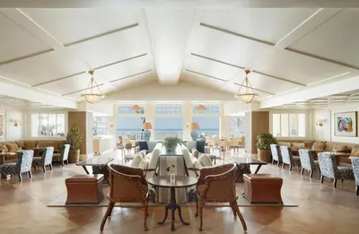 a dining room with tables and chairs in a building at Shutters On The Beach in Los Angeles