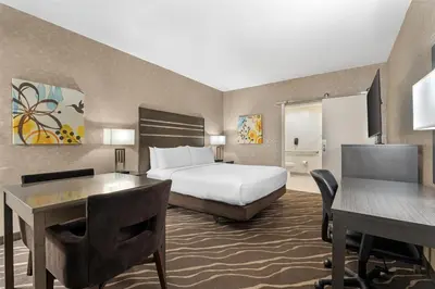 a hotel room with a bed and a desk at Best Western Plus Park Place Inn - Mini Suites in Anaheim