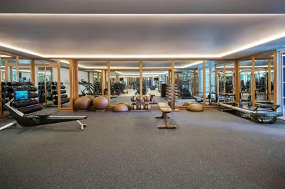 a gym with various exercise equipment in a building at The Maybourne Beverly Hills, Maybourne in Los Angeles