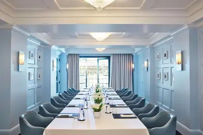 a large room with a long table and chairs at The Maybourne Beverly Hills, Maybourne in Los Angeles