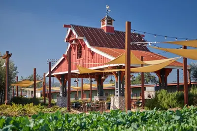 a red building with a red roof with yellow umbrellas at Sheraton Fairplex Suites & Conference Center in Pomona