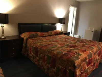 a hotel room with a large bed and a window at King Lodge Motel in Monterey Park