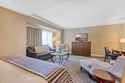 a hotel room with a bed and a living room at Omni Los Angeles Hotel in Los Angeles