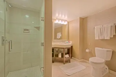 a bathroom with a shower and a toilet and a sink at Omni Los Angeles Hotel in Los Angeles