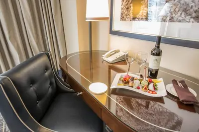 a table with a plate of food and a bottle of wine at Omni Los Angeles Hotel in Los Angeles