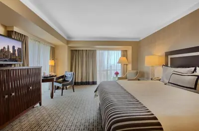 a hotel room with a large bed and a desk at Omni Los Angeles Hotel in Los Angeles