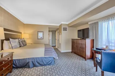 a hotel room with a bed and a flat screen tv at Omni Los Angeles Hotel in Los Angeles
