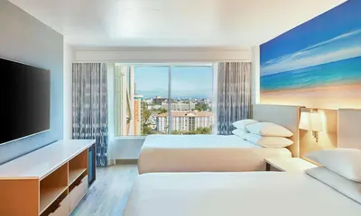 a hotel room with two beds and a large window at Hyatt Regency Orange County in Anaheim