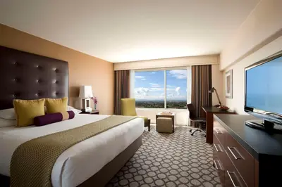 a hotel room with a large bed and a flat screen tv at Hyatt Regency Orange County in Anaheim