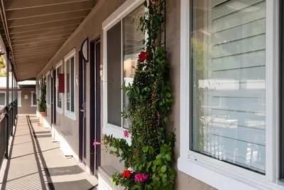 a building with flowers on the side of it at Alpine Inn near Convention Center and the Park in Anaheim