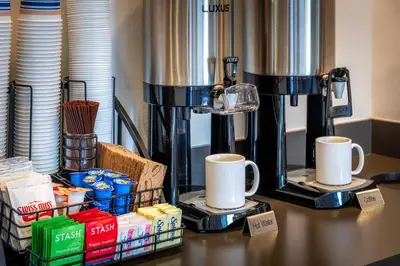 a table with two coffee machines and cups on it at Alpine Inn near Convention Center and the Park in Anaheim