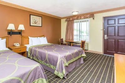 a hotel room with two beds and a window at Super 8 by Wyndham Azusa in Azusa
