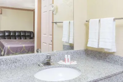 a bathroom with a sink and a mirror at Super 8 by Wyndham Azusa in Azusa