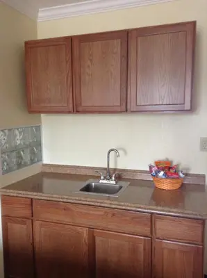 a kitchen with a sink and wooden cabinets at Best Inn & Suites in Anaheim