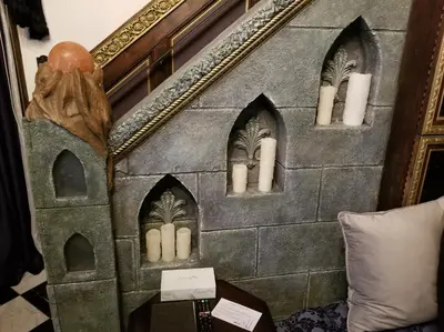 a room with a stone wall with a mirror at Castle Wood Theme Cottages- COUPLES ONLY in Big Bear Lake